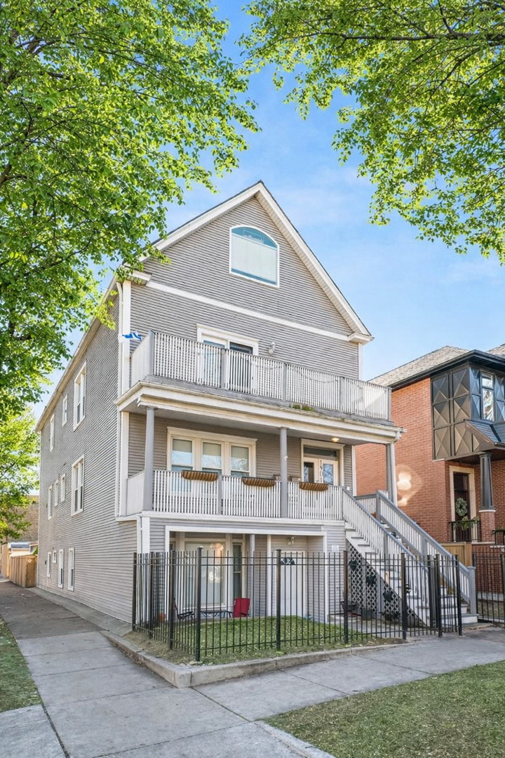 1901 West Fletcher Street, Unit 2 Chicago, IL 60657 - Photo 1 of 10 a front view of a house with a yard