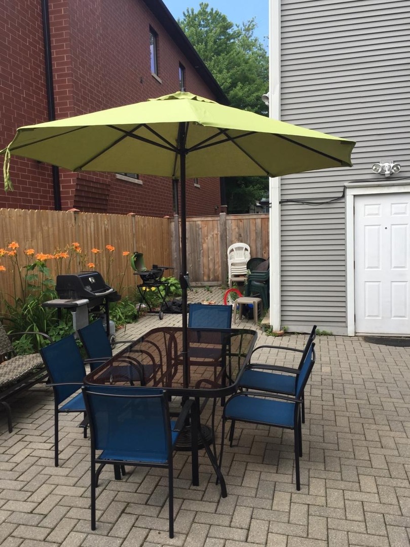 1901 West Fletcher Street, Unit 2 Chicago, IL 60657 - Photo 10 of 10 a view of backyard with outdoor seating and wooden fence