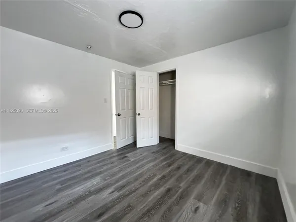 a view of an empty room and wooden floor