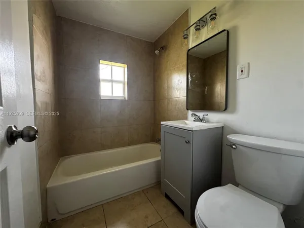 a bathroom with a toilet a sink and bathtub