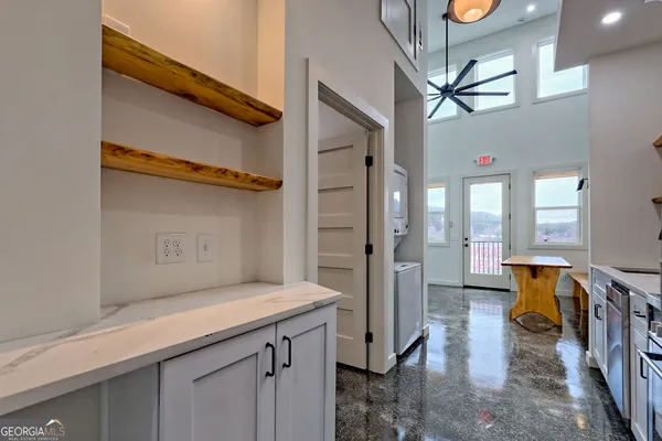 a bathroom with a granite countertop toilet a sink and a shower