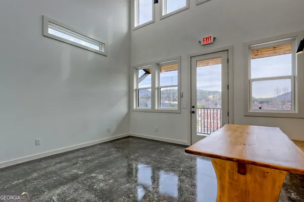 a large kitchen with stainless steel appliances a large counter top