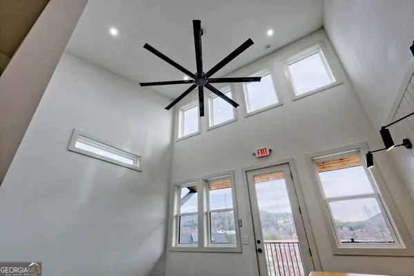 a kitchen with stainless steel appliances granite countertop a sink a stove a refrigerator cabinets and a window