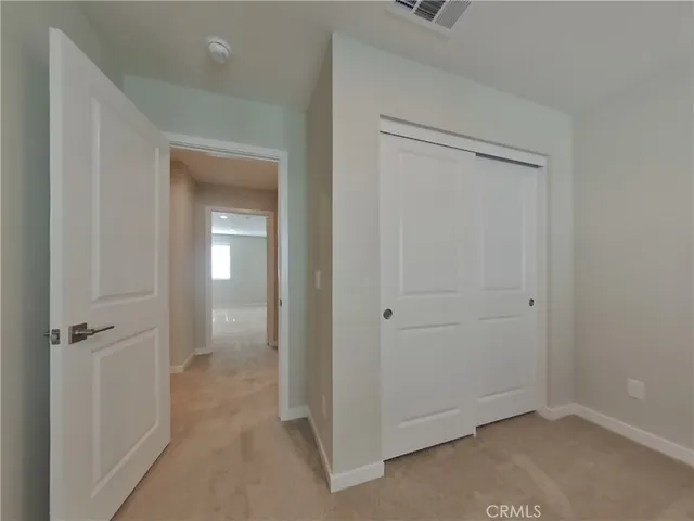 wooden floor in a hall way to a room
