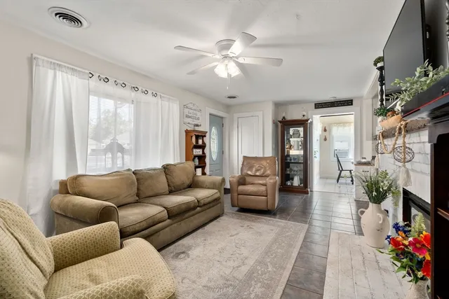 a living room with furniture a flat screen tv and a fireplace