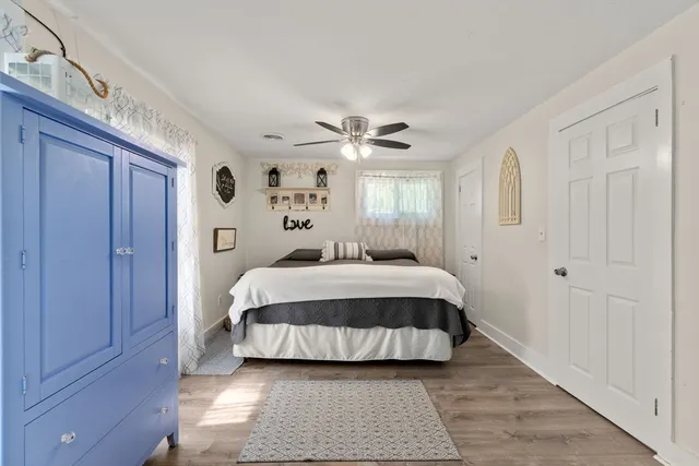 a spacious bedroom with a bed and window