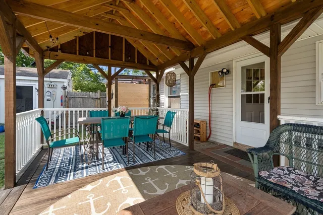 a view of a deck with wooden floor and outdoor seating