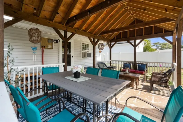 a patio with patio table and chairs with potted plants