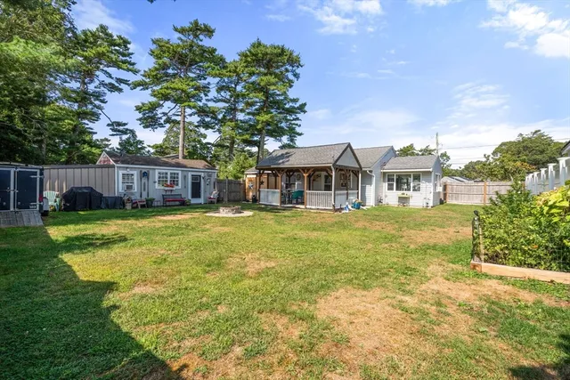 a front view of a house with a garden and trees