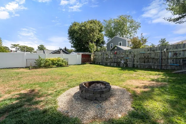 a view of a backyard with a garden and entertaining space