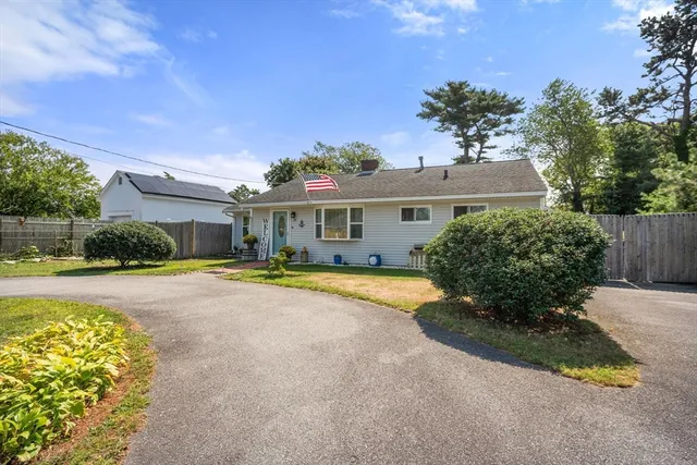 a view of a house with pool and a yard