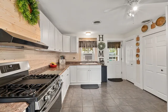 a kitchen with a stove a sink and a refrigerator
