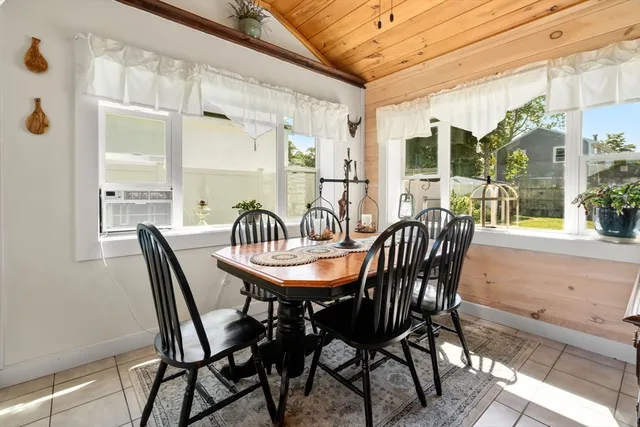 a dining room with furniture a chandelier and wooden floor