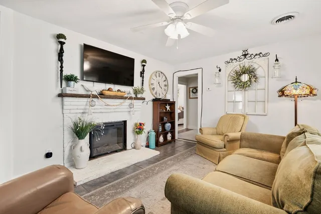 a living room with fireplace furniture and a flat screen tv