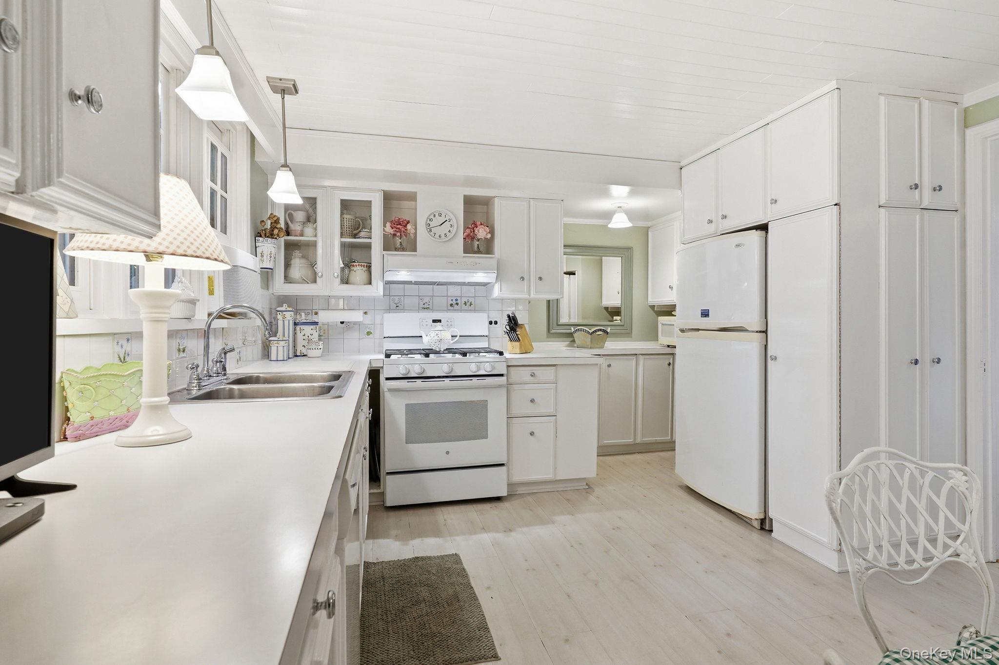 26 Cedarlawn Road Irvington, NY 10533 - Photo 12 of 34 a kitchen with white cabinets and white appliances