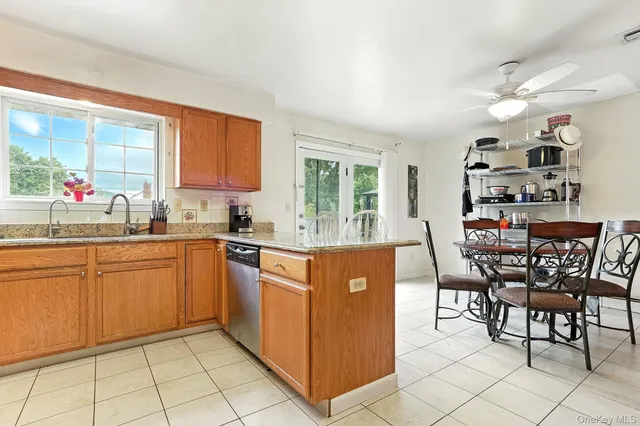 a kitchen with stainless steel appliances granite countertop a stove top oven a sink dishwasher and cabinets