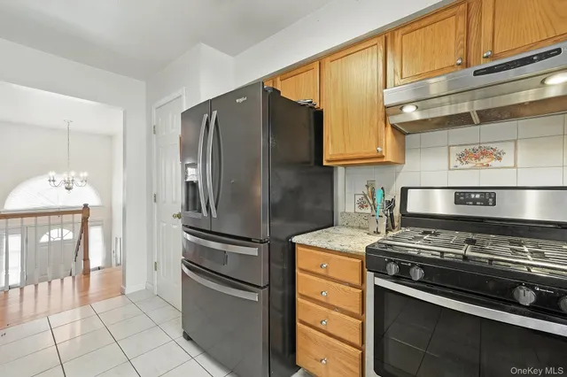a kitchen with stainless steel appliances granite countertop a refrigerator and a stove