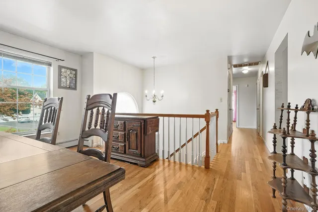 a view of a hallway with wooden floor and windows