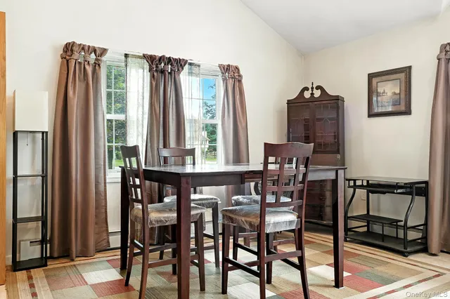 a dining room with furniture and window