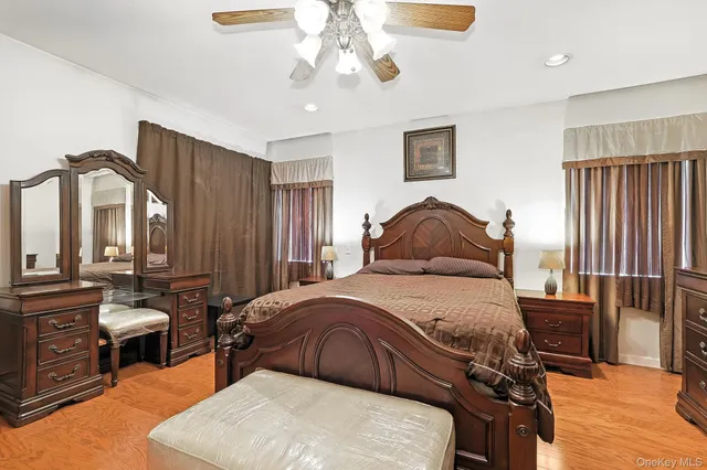 a bedroom with a bed a lamp and a chandelier