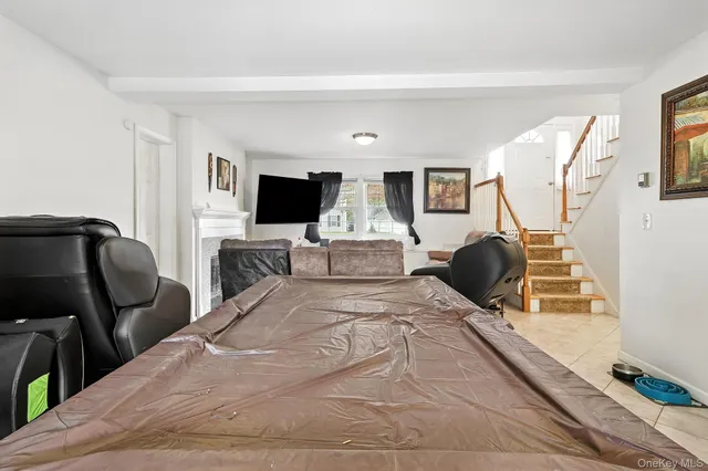 a spacious bedroom with a bed and wooden floor