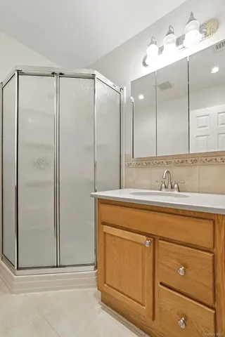 a bathroom with a shower sink and mirror