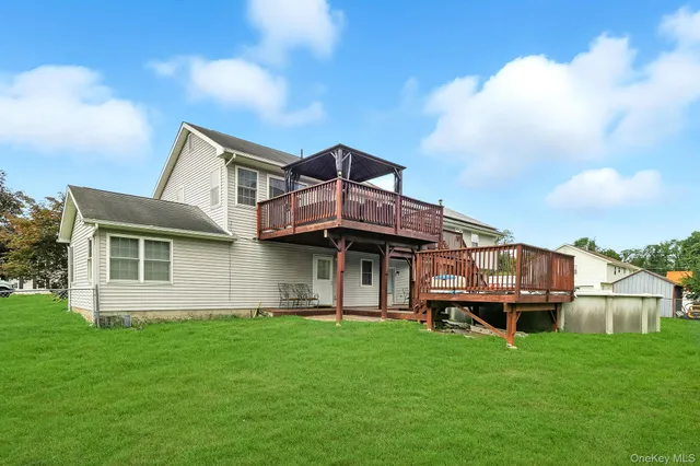 a front view of a house with a garden and deck