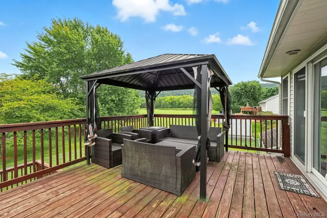 a view of a balcony with floor to ceiling window wooden floor and fence