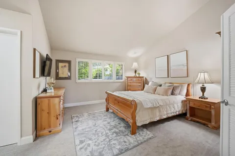 a bedroom with a bed and a flat screen television