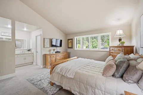a bedroom with a large bed and a flat screen tv