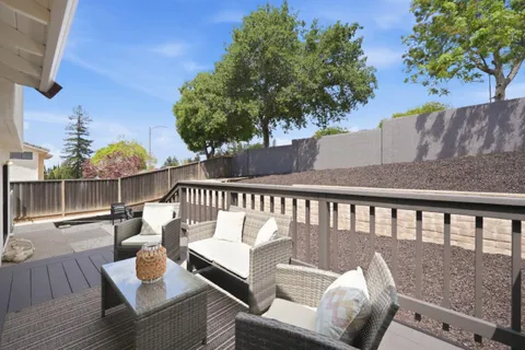 a balcony with wooden floor and fence