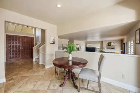 a view of a dining room with furniture and a potted plant