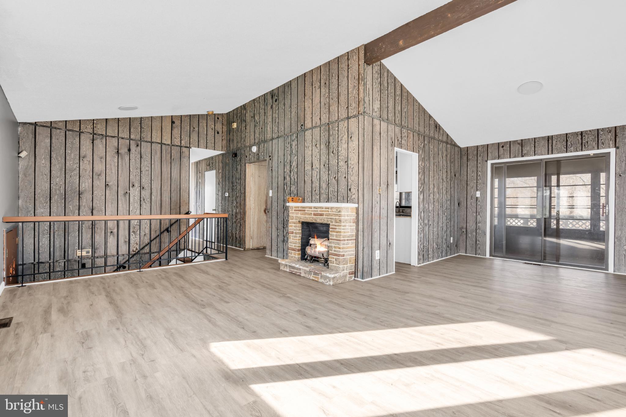 22 Pershing Lane Sicklerville, NJ 08081 - Photo 11 of 34 a view of an empty room with wooden floor and fireplace