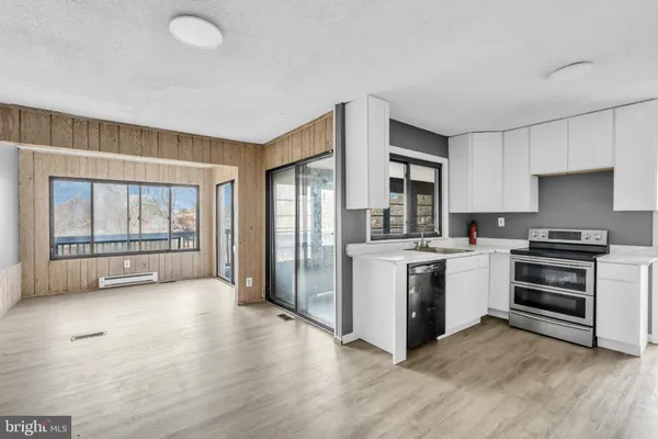 a kitchen with stainless steel appliances a stove top oven and a refrigerator