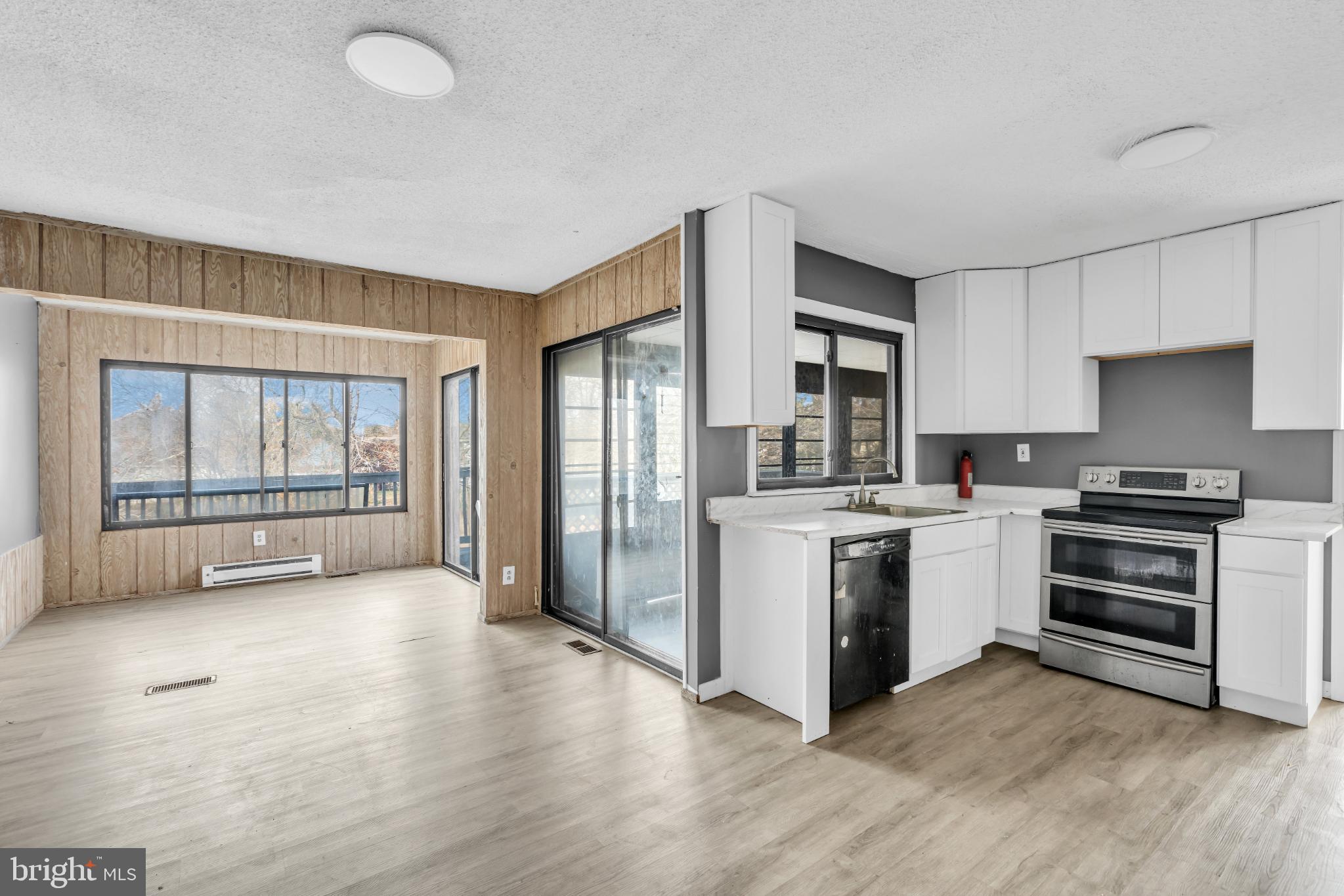 22 Pershing Lane Sicklerville, NJ 08081 - Photo 15 of 34 a kitchen with stainless steel appliances a stove top oven and a refrigerator