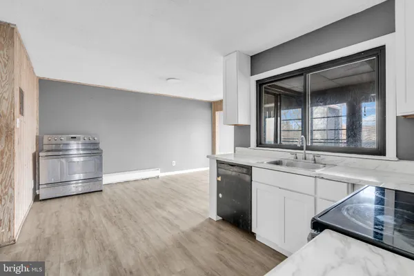 a kitchen with stainless steel appliances a sink and a refrigerator