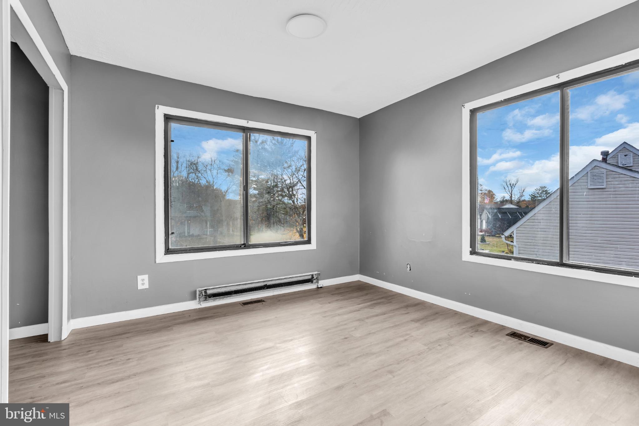 22 Pershing Lane Sicklerville, NJ 08081 - Photo 21 of 34 a view of an empty room with a window and wooden floor