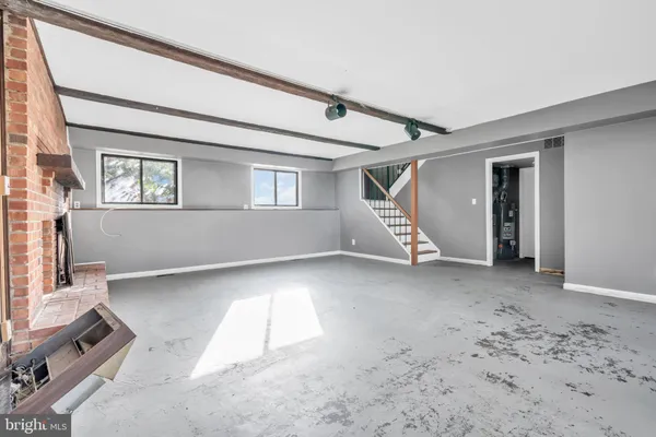 a view of a livingroom with entryway window and stairs