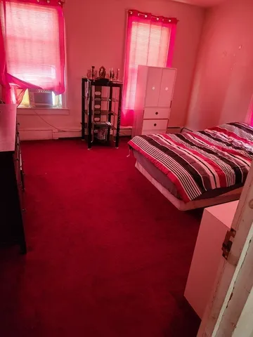 a room with a bed furniture and a potted plant