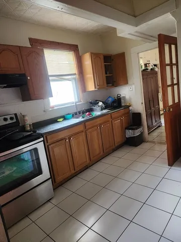a kitchen with stainless steel appliances granite countertop a sink and a stove