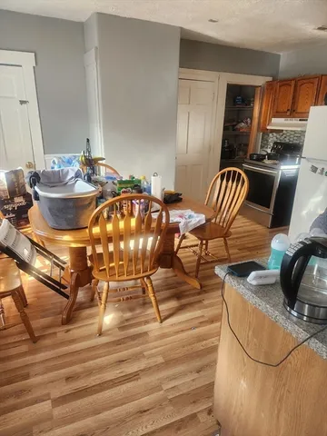 a view of a dining room with furniture and wooden floor