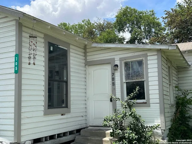 a front view of a house with trees