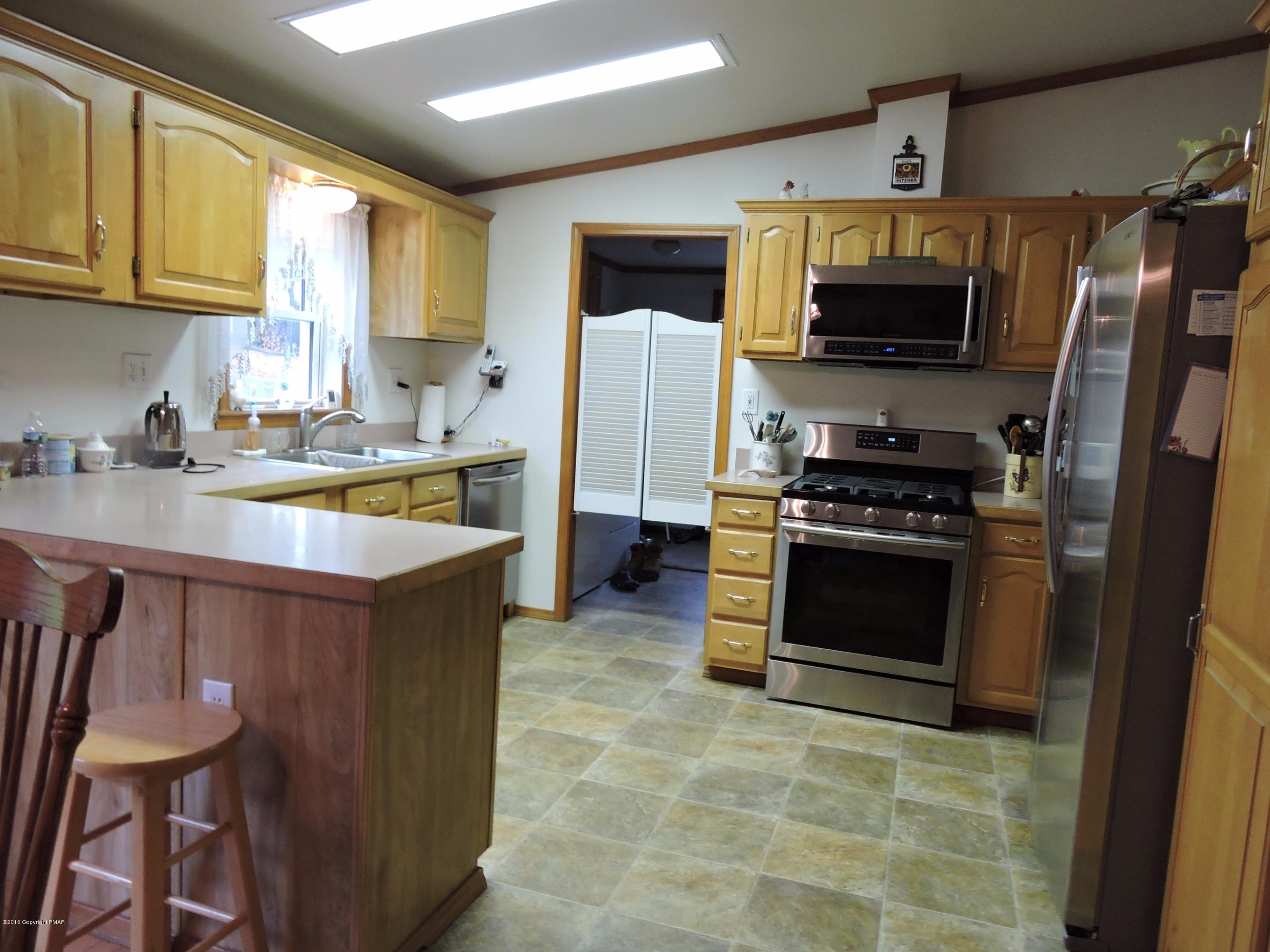211 Five Springs Road Stroudsburg, PA 18360 - Photo 3 of 18 a kitchen with stainless steel appliances granite countertop a stove top oven a sink dishwasher a refrigerator and a microwave