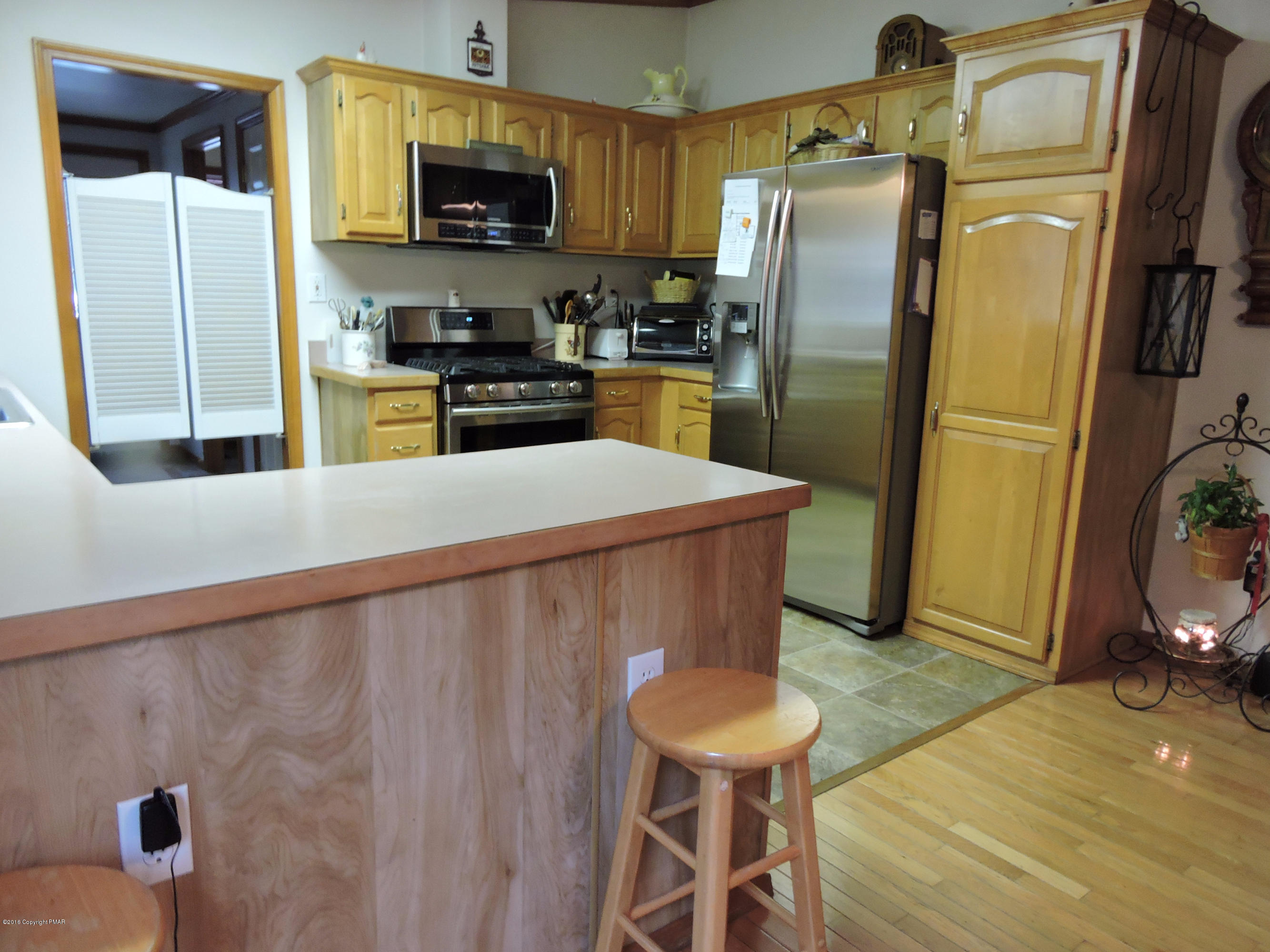 211 Five Springs Road Stroudsburg, PA 18360 - Photo 4 of 18 a kitchen with stainless steel appliances a refrigerator and a stove top oven