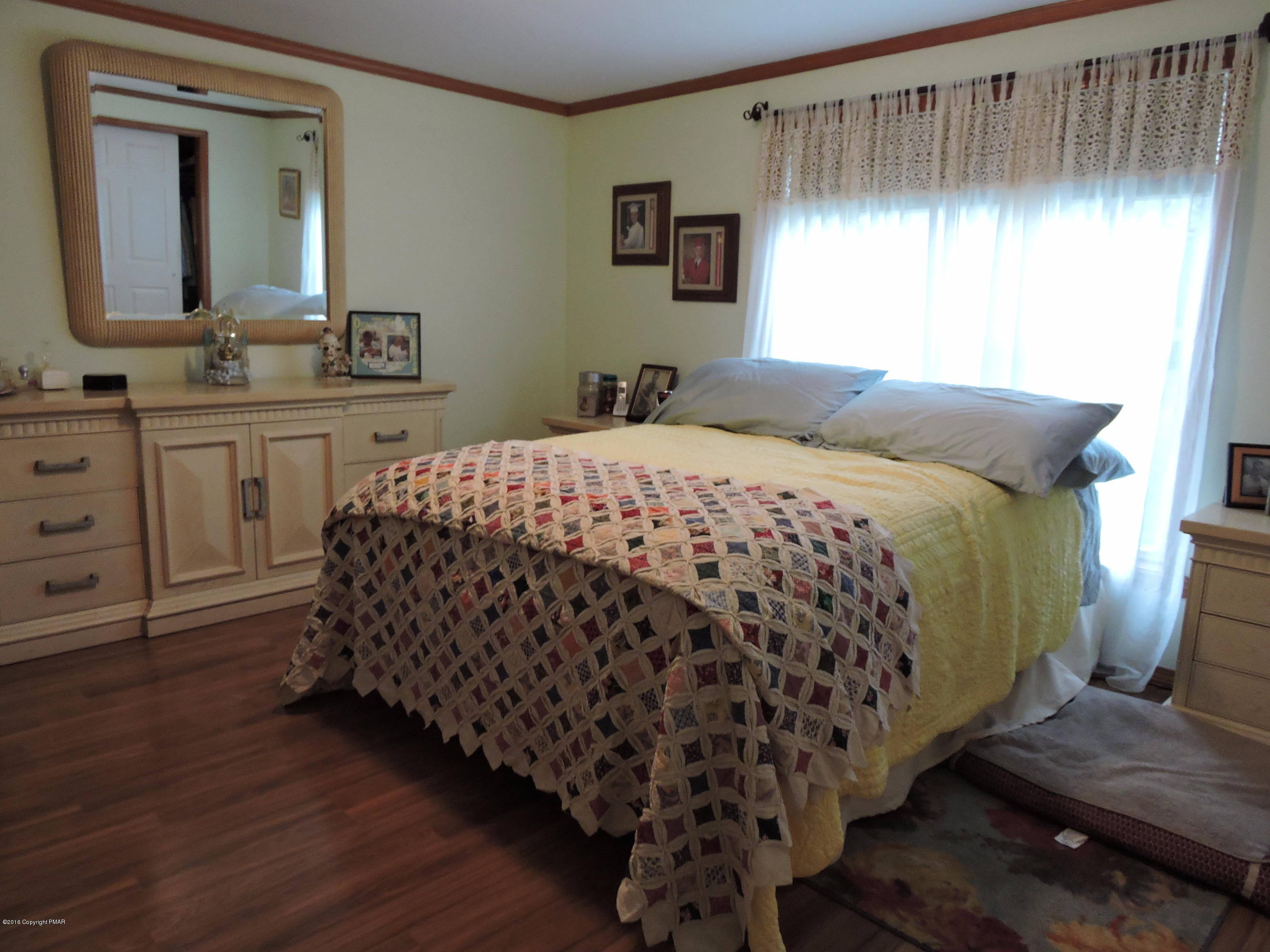 211 Five Springs Road Stroudsburg, PA 18360 - Photo 10 of 18 a bedroom with a bed and a mirror on dresser