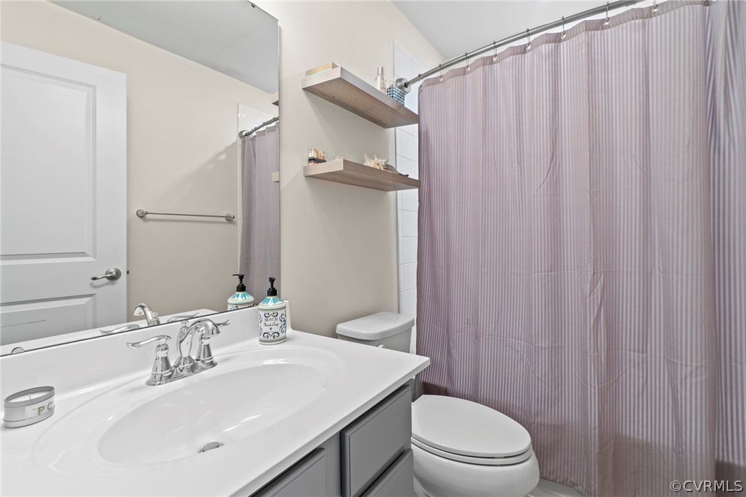 5505 Riverside Heights Way Richmond, VA 23225 - Photo 15 of 30 a bathroom with a sink a toilet and shower curtain