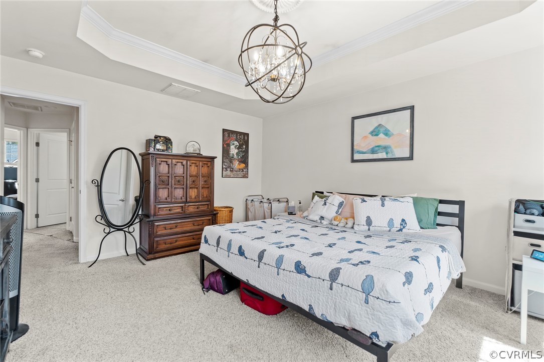 5505 Riverside Heights Way Richmond, VA 23225 - Photo 18 of 30 a bedroom with bed and a chandelier