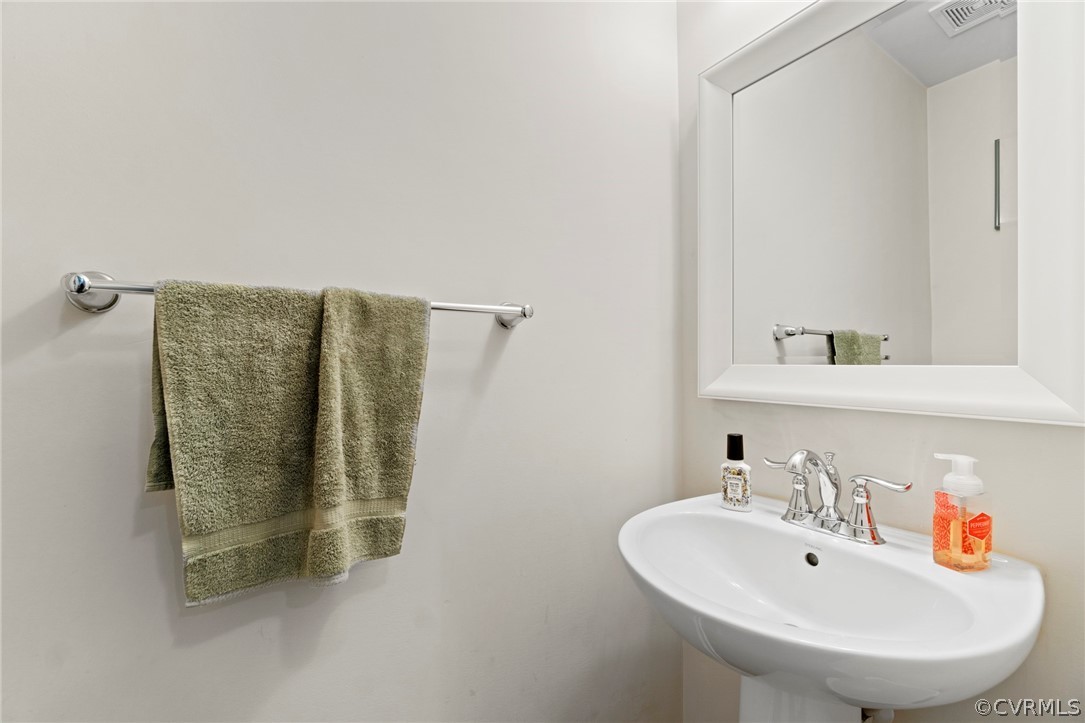 5505 Riverside Heights Way Richmond, VA 23225 - Photo 27 of 30 a bathroom with a sink and a mirror