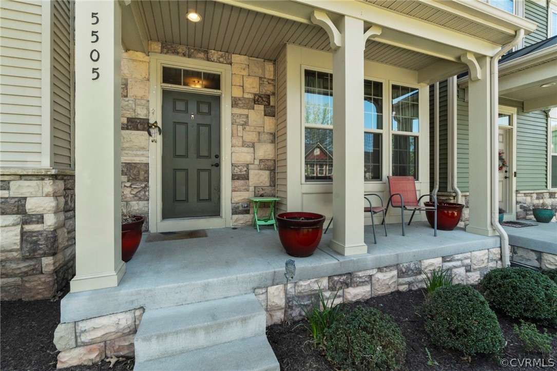 5505 Riverside Heights Way Richmond, VA 23225 - Photo 3 of 30 a view of a patio with table and chairs and potted plants