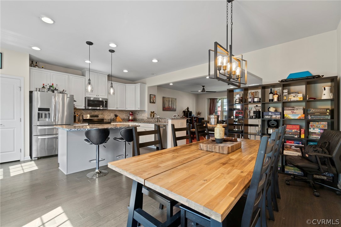 5505 Riverside Heights Way Richmond, VA 23225 - Photo 8 of 30 a room with stainless steel appliances kitchen island a table and chairs in it